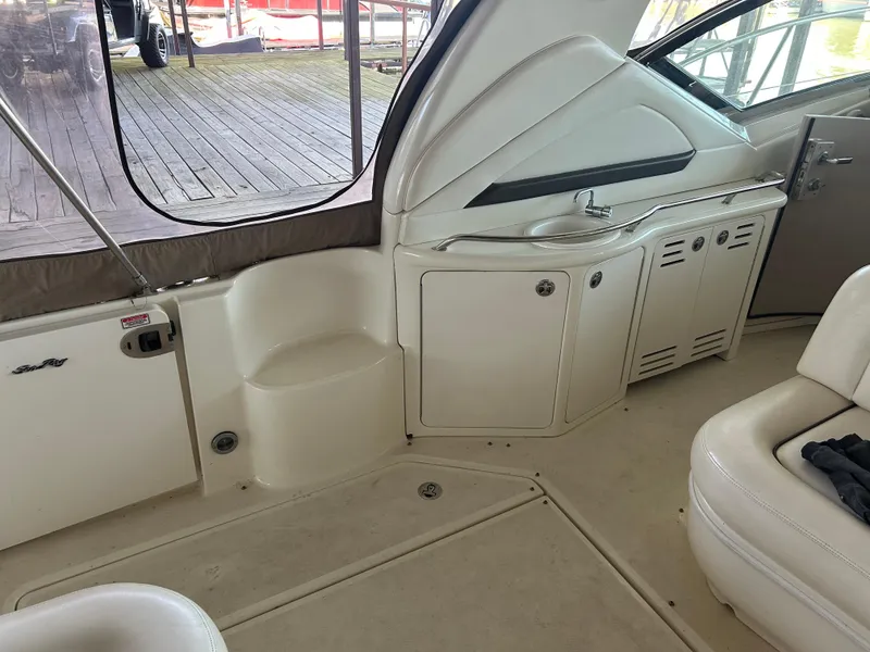 Slide: The Image of 2004 Sea Ray 420 Sundancer interior with seating and cabinetry. - 27