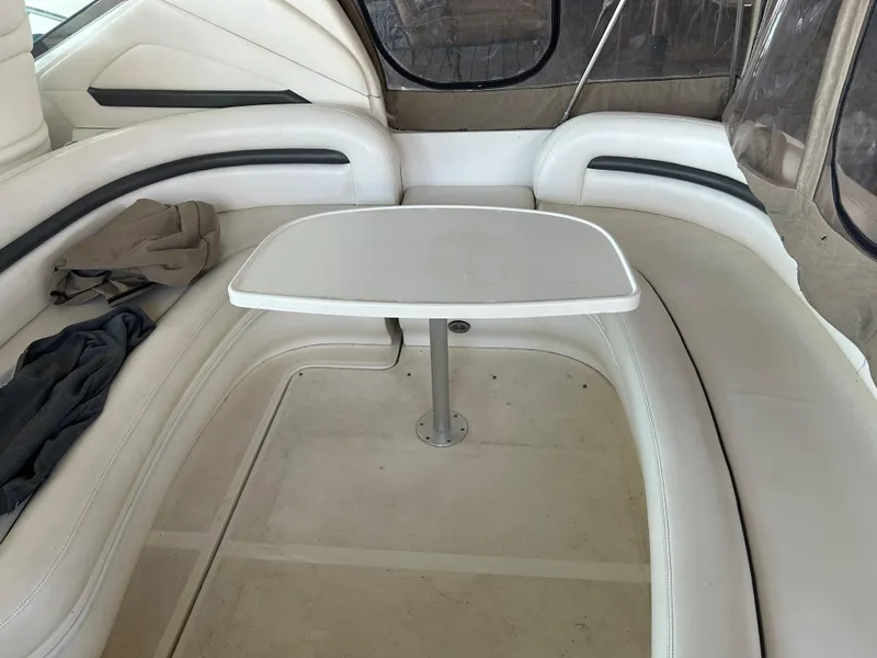 Slide: The Image of 2004 Sea Ray 420 Sundancer interior with white seating and table. - 29