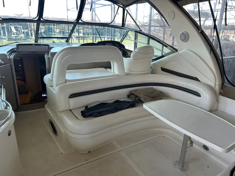 Slide: The Image of 2004 Sea Ray 420 Sundancer interior with white seating and table. - 30