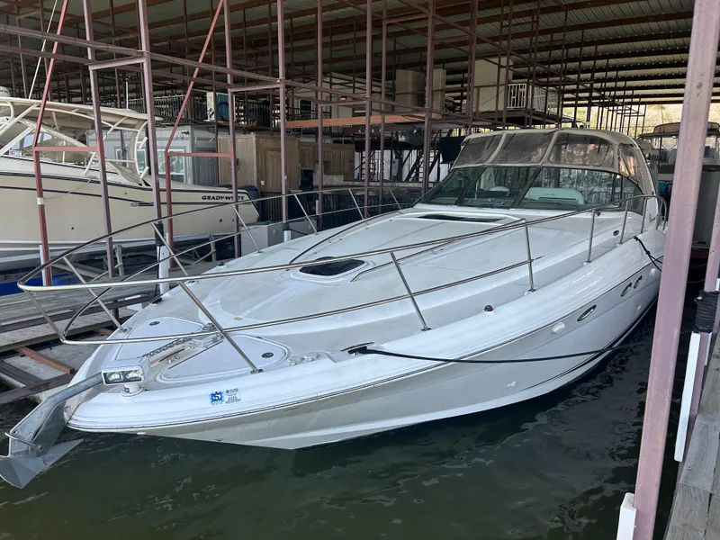 Slide: The Image of 2004 Sea Ray 420 Sundancer docked in a marina, showcasing sleek design and spacious deck. - 31