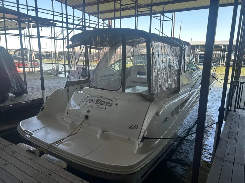 Slide: The Image of 2004 Sea Ray 420 Sundancer docked under a covered marina. - 32