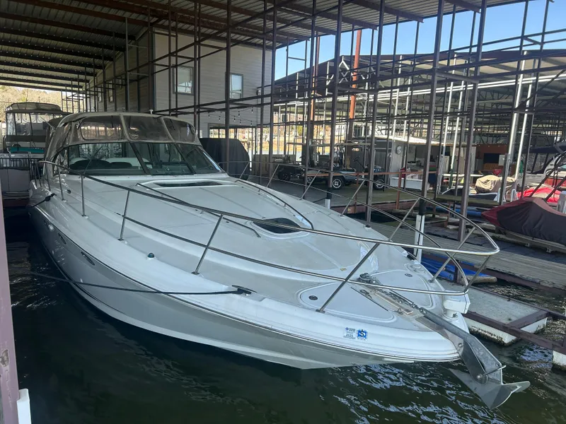 Slide: The Image of 2004 Sea Ray 420 Sundancer yacht docked in a marina under a covered structure. - 33