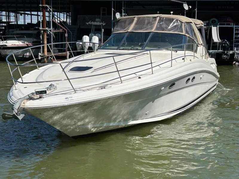 Slide: The Image of 2004 Sea Ray 420 Sundancer yacht docked on calm water. - 4