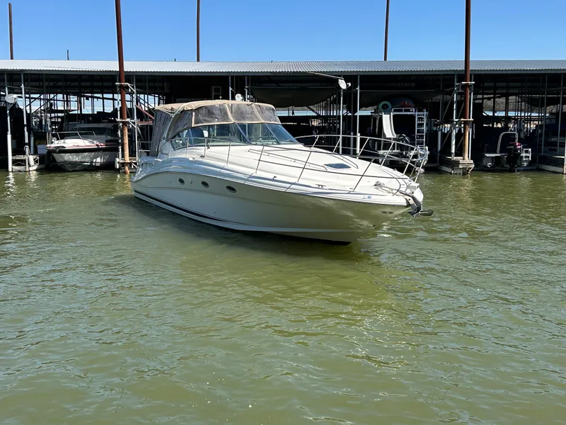 Slide: The Image of 2004 Sea Ray 420 Sundancer yacht docked in marina, calm waters, clear sky. - 6