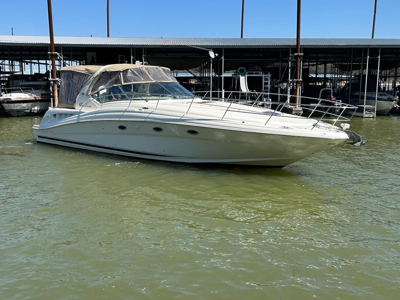 Slide: The Image of 2004 Sea Ray 420 Sundancer yacht docked in marina, calm water, clear sky. - 7
