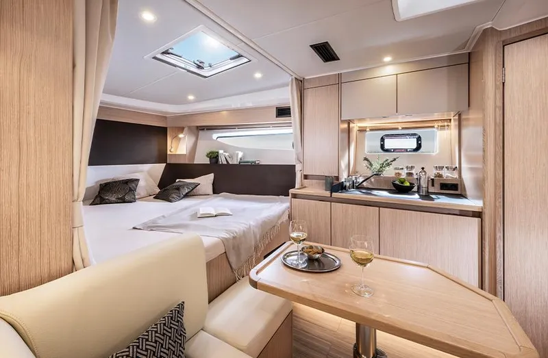 Slide: The Image of Luxurious interior of 2025 Bavaria SR33 yacht with cozy bed and modern kitchenette. - 18