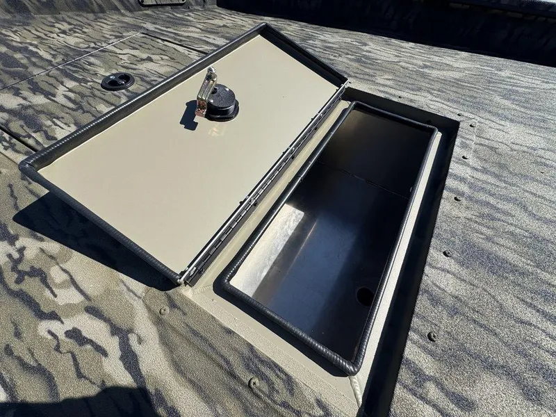 Slide: The Image of 2025 SeaArk 1752 Slayer Pro boat with open storage compartment. - 11