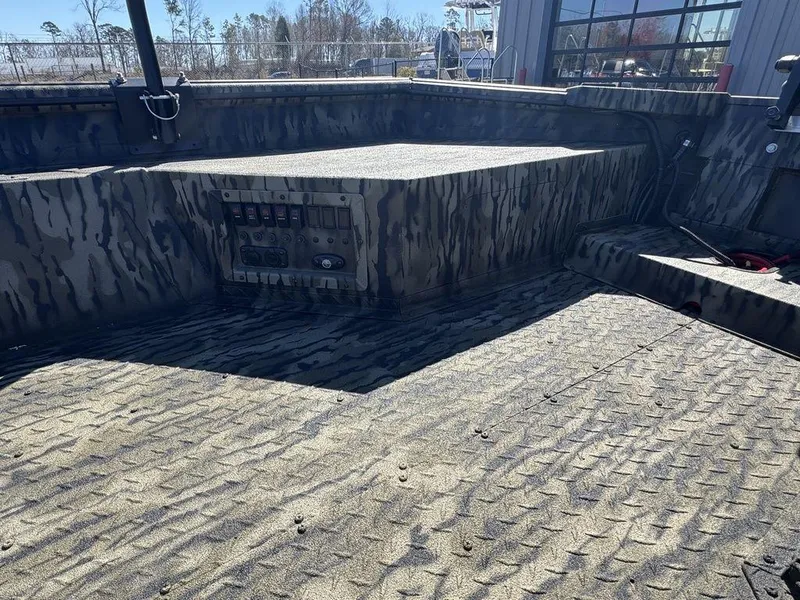 Slide: The Image of 2025 SeaArk 1752 Slayer Pro boat interior with camo design and control panel. - 15