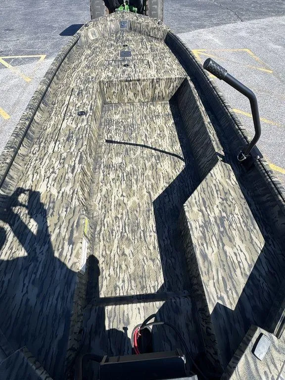 Slide: The Image of 2025 SeaArk 1752 Slayer Pro boat with camouflage interior design. - 16