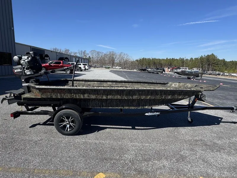 Slide: The Image of 2025 SeaArk 1752 Slayer Pro boat on trailer, parked outdoors. - 4