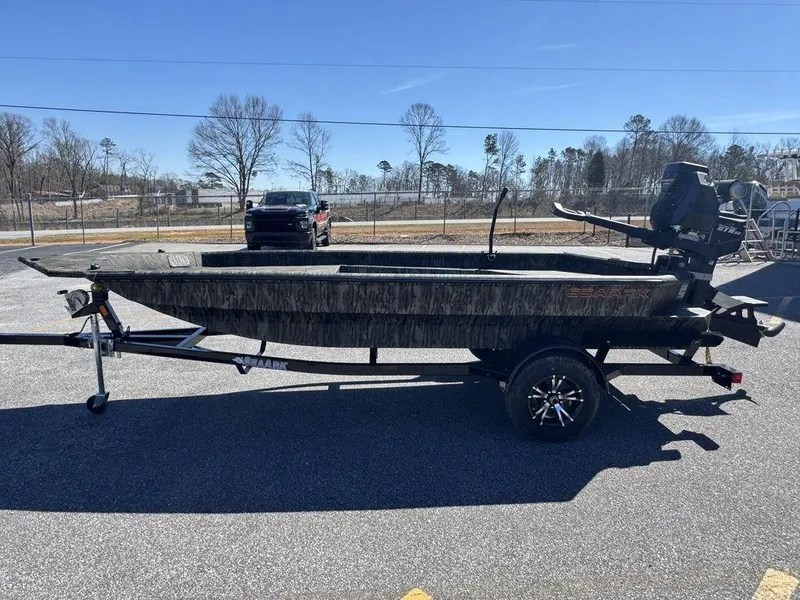 Slide: The Image of 2025 SeaArk 1752 Slayer Pro boat on trailer, parked outdoors. - 9