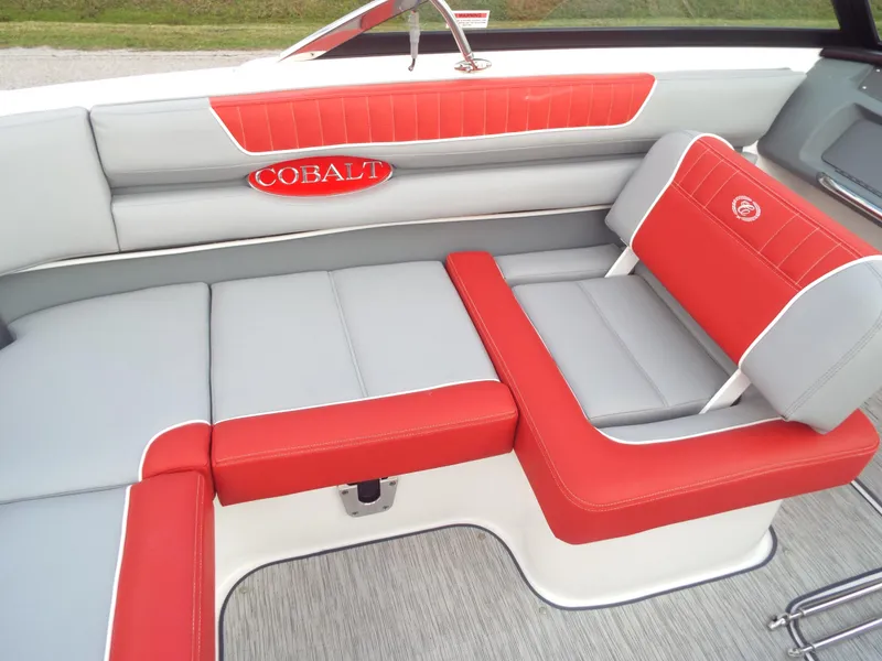 Slide: The Image of 2021 Cobalt CS22 boat interior with red and gray seating. - 7