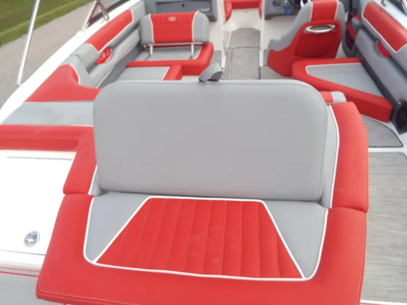 Slide: The Image of 2021 Cobalt CS22 boat interior with red and gray seating. - 8