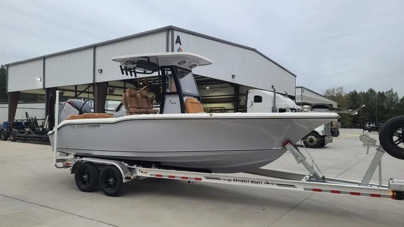 Slide: The Image of 2025 Key West 239 FSR boat on trailer outside a warehouse. - 1