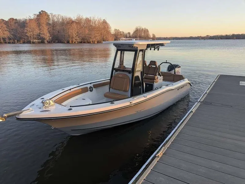 Slide: The Image of 2025 Key West 239 FSR boat docked on a calm lake at sunset. - 2