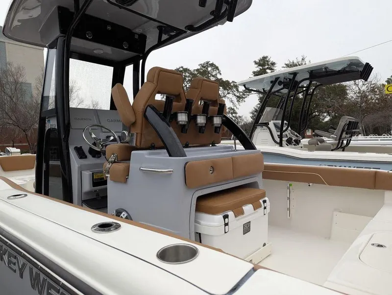 Slide: The Image of 2025 Key West 239 FSR boat interior with tan seating and console. - 5