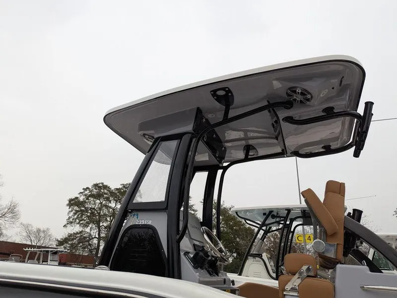 Slide: The Image of 2025 Key West 239 FSR boat with T-top and seating, overcast sky background. - 6
