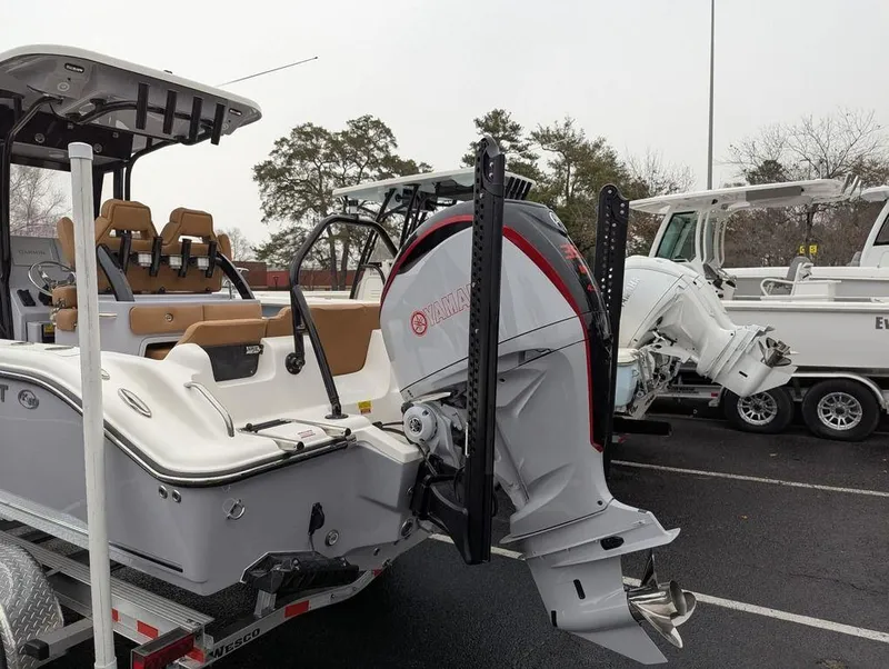 Slide: The Image of 2025 Key West 239 FSR boat with powerful outboard motor, parked on a trailer. - 7