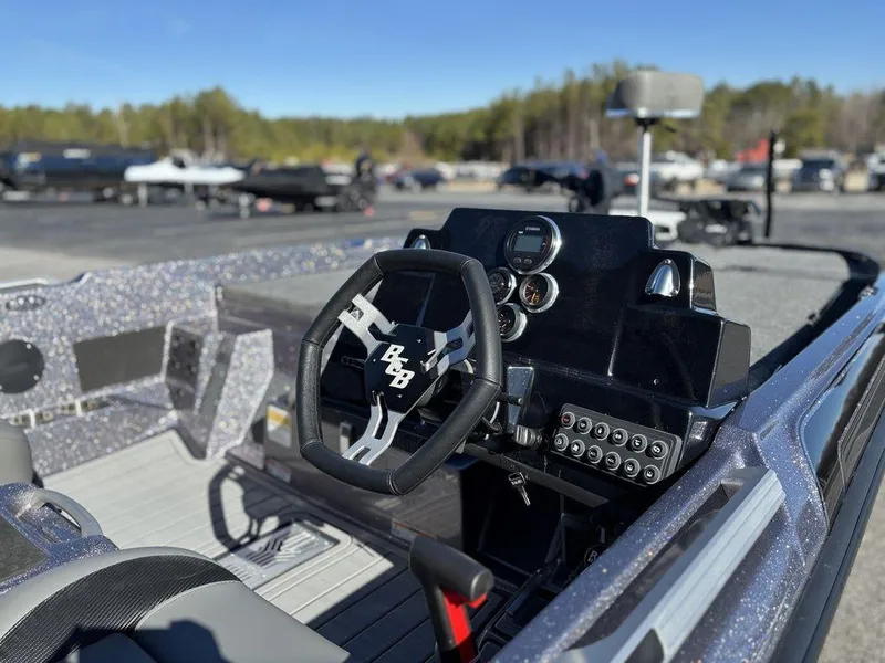 Slide: The Image of 2025 Bass Cat Puma STS boat interior with steering wheel and dashboard controls. - 10