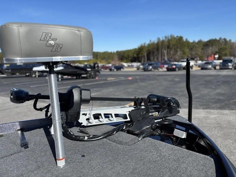 Slide: The Image of 2025 Bass Cat Puma STS boat with motor, parked outdoors on a sunny day. - 13