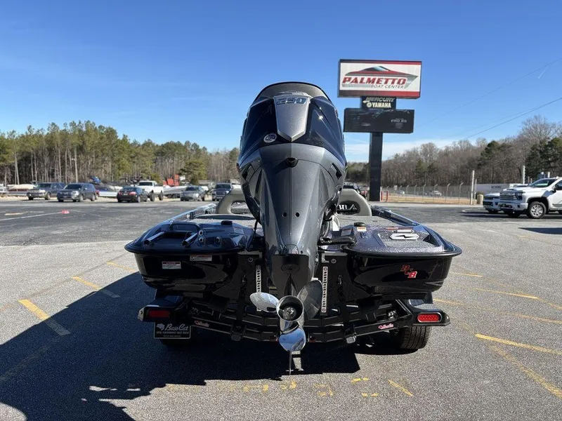 Slide: The Image of 2025 Bass Cat Puma STS boat with powerful outboard motor in parking lot. - 3