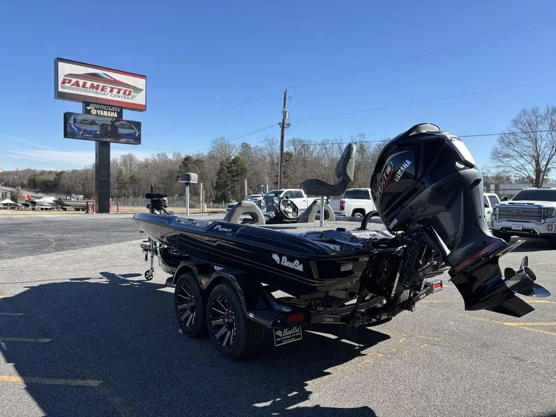 Slide: The Image of 2025 Bass Cat Puma STS boat with Yamaha engine in dealership parking lot. - 4