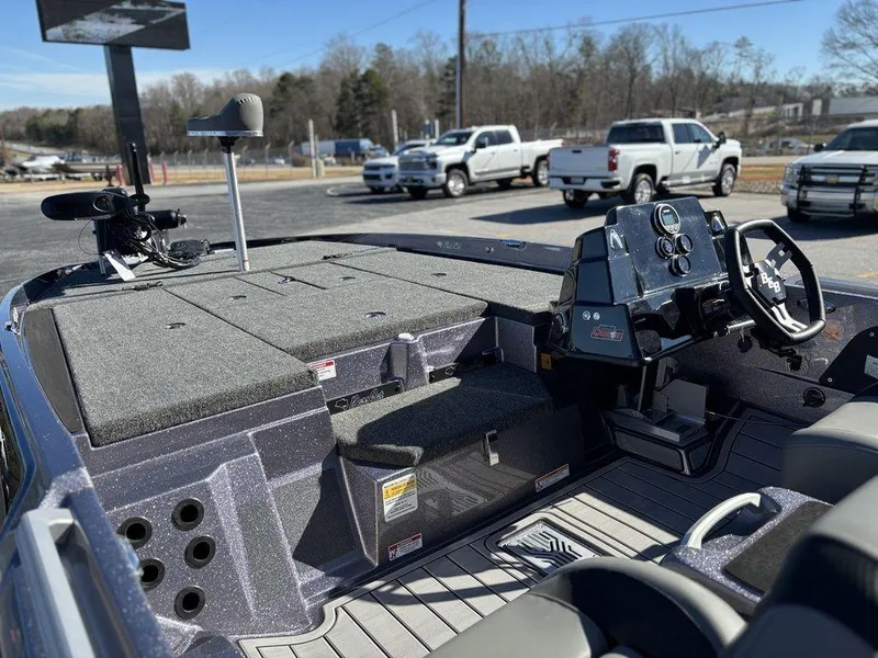 Slide: The Image of 2025 Bass Cat Puma STS boat interior with steering console and storage compartments. - 6