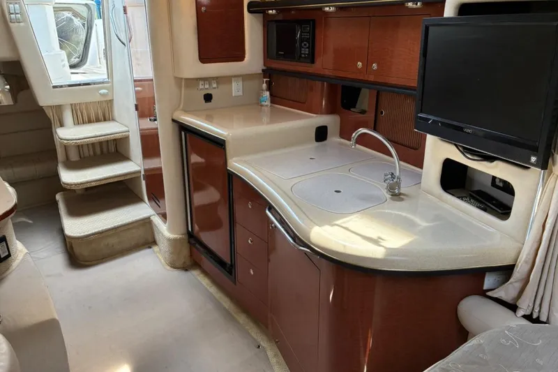 Slide: The Image of Interior of 2002 Sea Ray 340 Sundancer yacht with kitchenette and TV. - 13