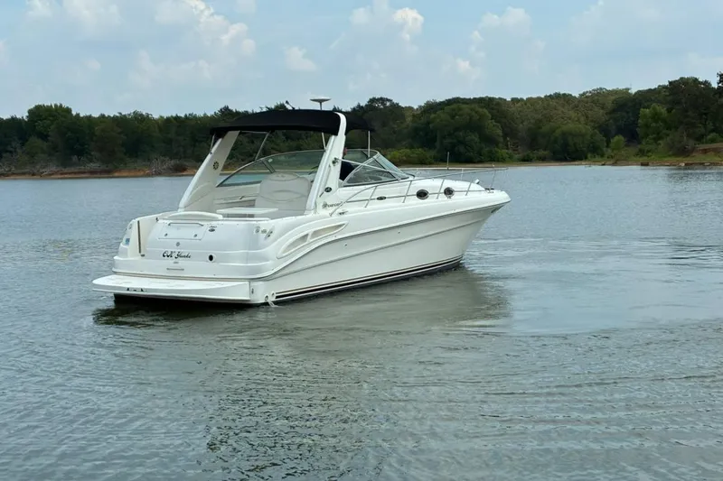 Slide: The Image of 2002 Sea Ray 340 Sundancer boat cruising on a calm lake. - 15