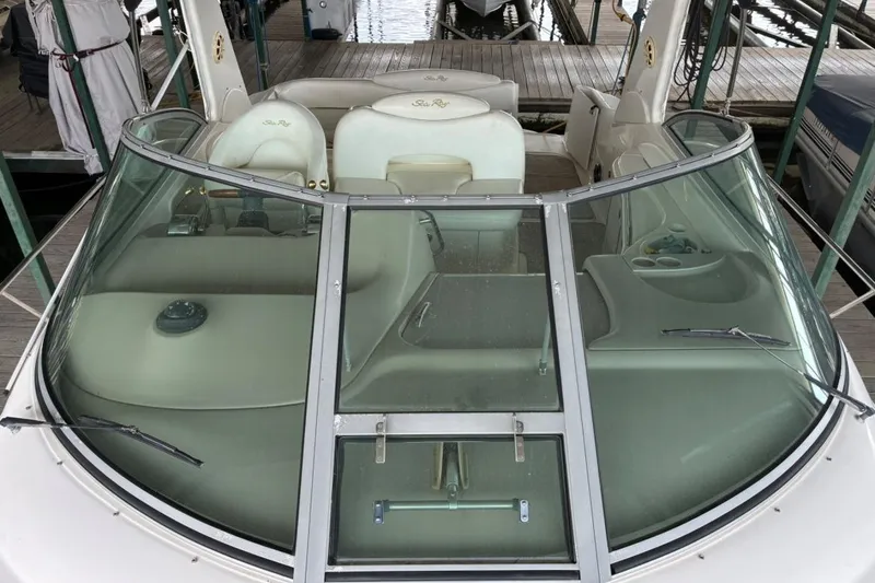 Slide: The Image of 2002 Sea Ray 340 Sundancer boat with sleek windshield and luxurious seating. - 16