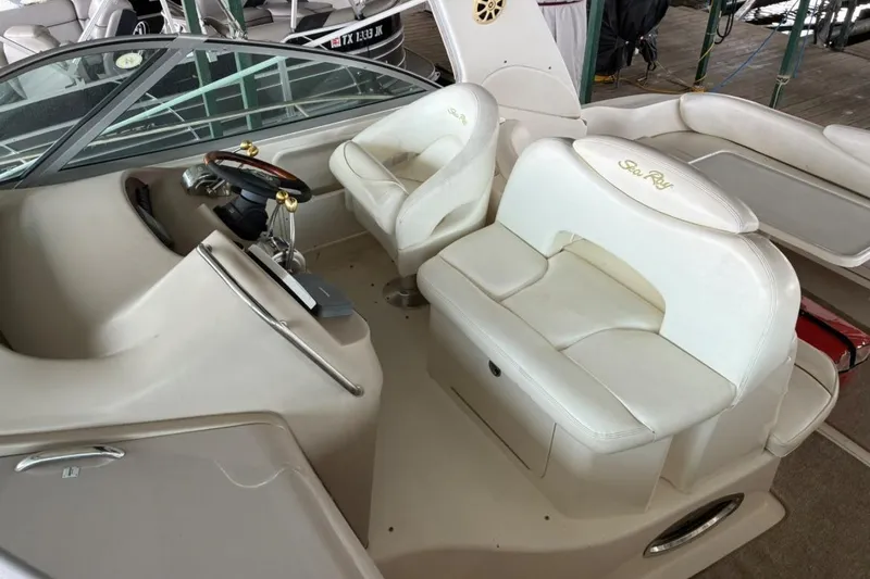 Slide: The Image of 2002 Sea Ray 340 Sundancer cockpit with white leather seating and steering wheel. - 17