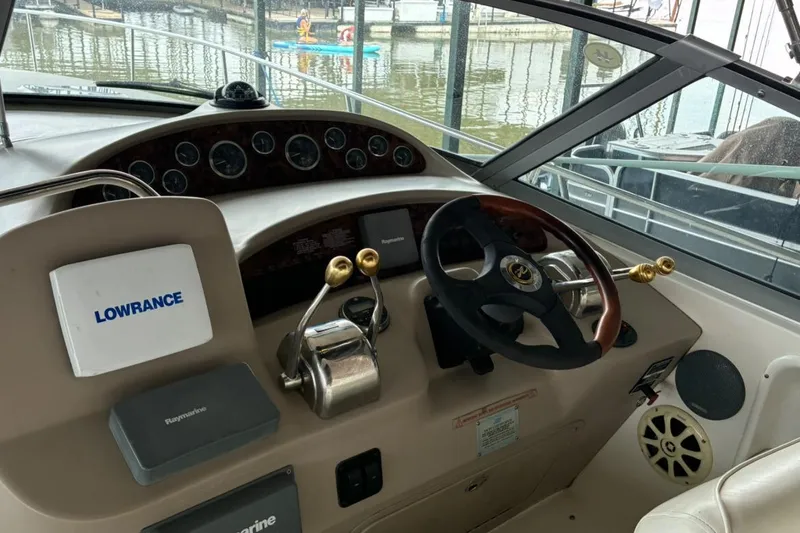 Slide: The Image of 2002 Sea Ray 340 Sundancer helm with Lowrance and Raymarine equipment, docked at marina. - 19