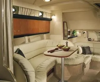 Slide: The Image of 2002 Sea Ray 340 Sundancer boat on calm water, surrounded by trees and cloudy sky. - 4