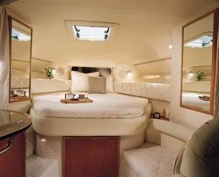 Slide: The Image of 2002 Sea Ray 340 Sundancer cruising on a calm lake with a scenic backdrop. - 6