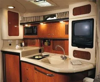 Slide: The Image of 2002 Sea Ray 340 Sundancer cruising on a calm lake with wooded shoreline. - 7