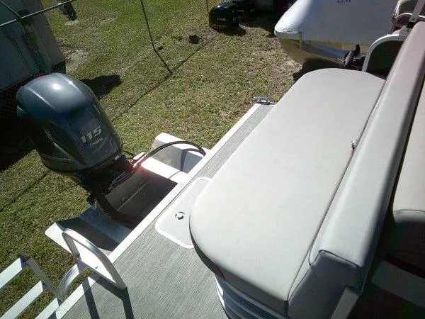 Slide: The Image of 2023 Bennington 208SLJ Tri-toon boat with 115 horsepower outboard motor, rear seating view. - 5
