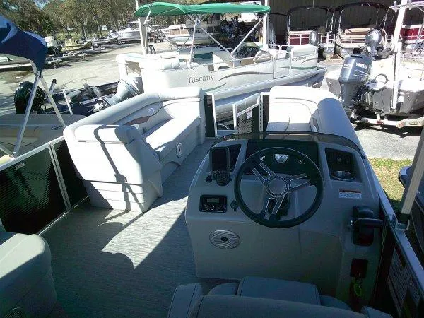 Slide: The Image of 2023 Bennington 208SLJ Tri-toon boat interior with steering wheel and seating area. - 6