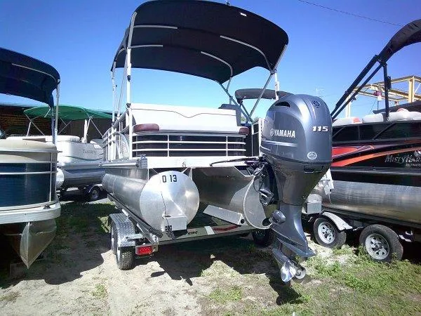 Slide: The Image of 2023 Bennington 208SLJ Tri-toon with Yamaha 115 engine on trailer. - 9
