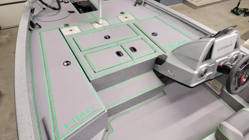 Slide: The Image of 2023 Xpress H18C Crappie boat interior with Garmin system, showcasing storage and seating. - 13