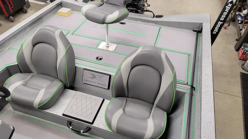 Slide: The Image of 2023 Xpress H18C Crappie boat interior with gray and green seating, in stock. - 17