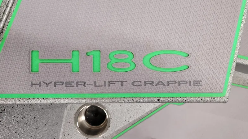 Slide: The Image of 2023 Xpress H18C Hyper-Lift Crappie boat detail with green accents. - 4