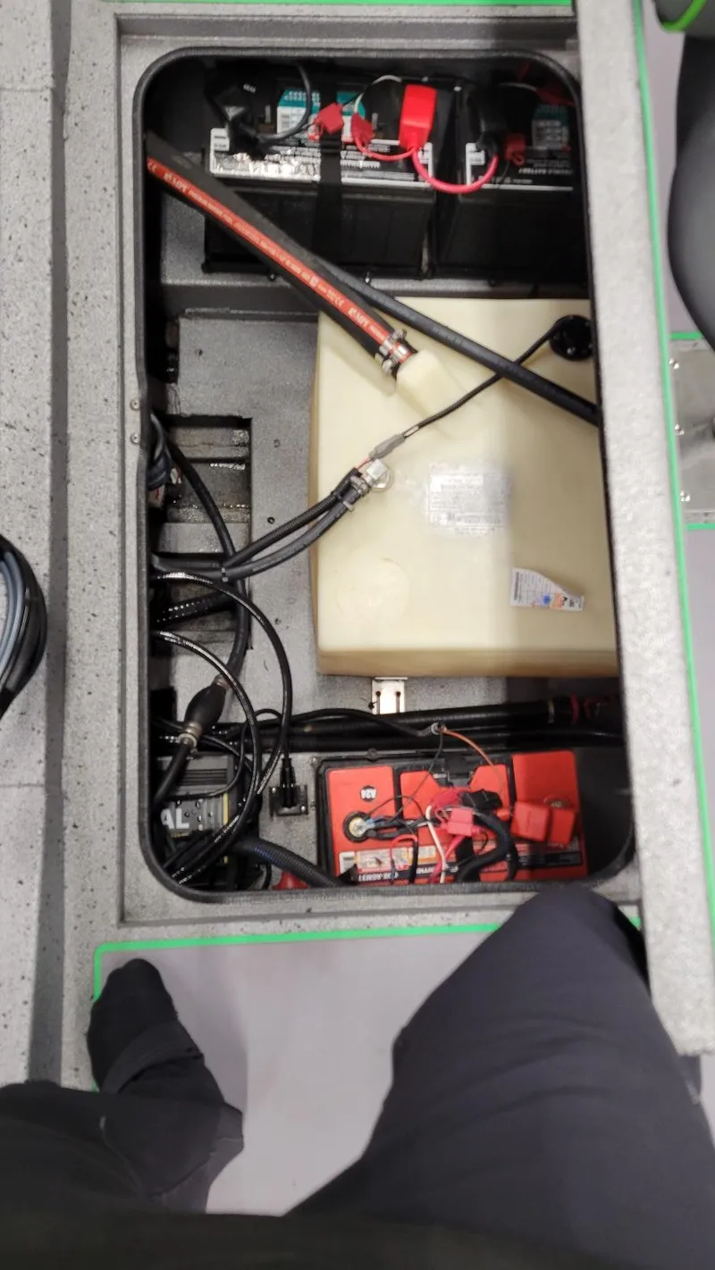 Slide: The Image of 2023 Xpress H18C Crappie boat interior showing battery and wiring components. - 7