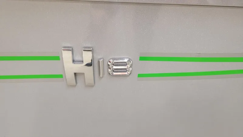 Slide: The Image of 2023 Xpress H18C Crappie boat emblem with green stripes, featuring Yamaha Vmax 115 SHO. - 9