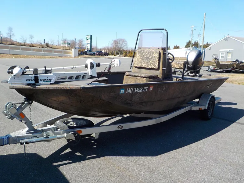 Slide: The Image of 2019 G3 Bay 20 DLX Camo boat on trailer, featuring Minn Kota trolling motor. - 15