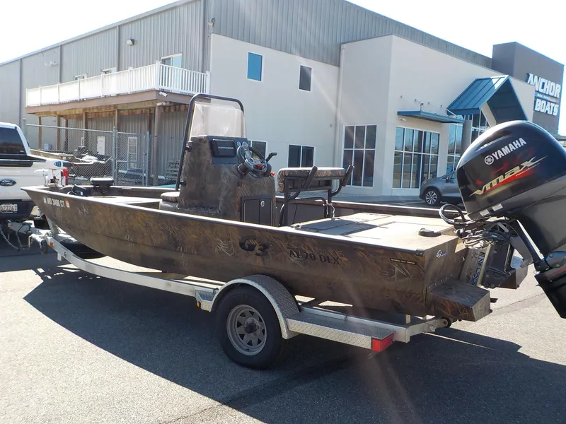Slide: The Image of 2019 G3 Bay 20 DLX Camo boat on trailer with Yamaha outboard motor. - 16