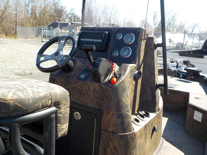 Slide: The Image of 2019 G3 Bay 20 DLX Camo boat dashboard with steering wheel and controls. - 18