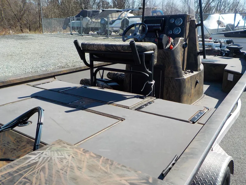 Slide: The Image of 2019 G3 Bay 20 DLX Camo boat with camouflage design, parked outdoors. - 8