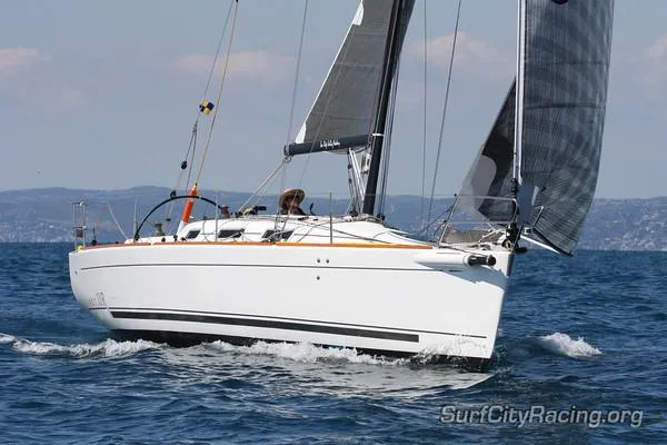 Slide: The Image of 2007 Beneteau First 10R sailboat navigating on open water. - 4