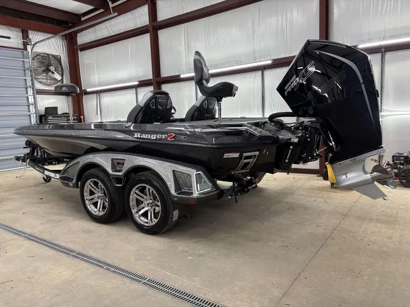 Slide: The Image of 2025 Ranger Z519R boat in a garage, featuring a sleek design and powerful engine. - 5
