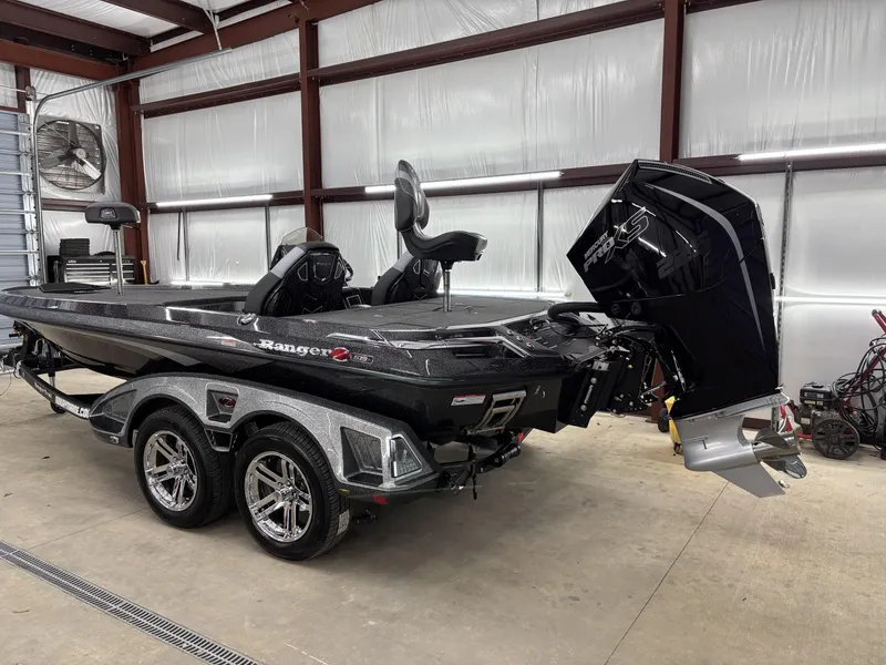 Slide: The Image of 2025 Ranger Z519R bass boat in a garage, featuring a powerful outboard motor. - 6